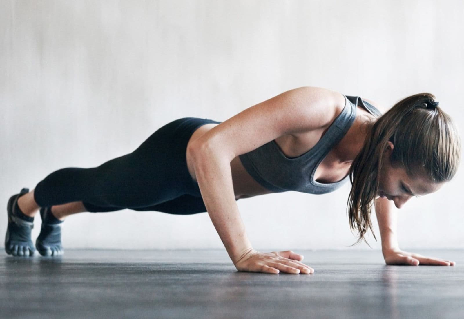 A Science Fitness client holding a strong push-up position in the private San Diego studio